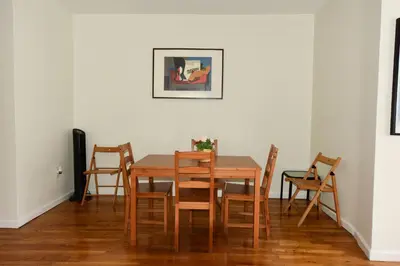 a dining room with a wooden table and chairs at Great! Private NYC Room in Sunnyside in Haberman
