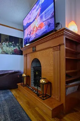a living room with a fireplace with a flat screen tv at Sweet Home - Zoller Stays in Long Island City