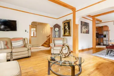 a living room with a glass table and chairs at Sweet Home - Zoller Stays in Long Island City