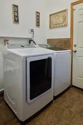 a white microwave sitting next to a washer at Sweet Home - Zoller Stays in Long Island City