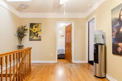 an empty hallway with a refrigerator in a house at Sweet Home - Zoller Stays in Long Island City