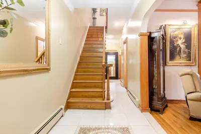 a staircase in a home with a mirror at Sweet Home - Zoller Stays in Long Island City