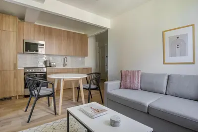 a living room with a couch and a table at Blueground E Village rooftop pool gym ac NYC-1533 in New York