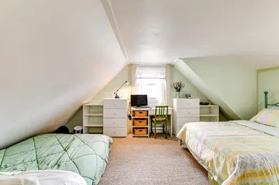 a attic bedroom with two beds and a desk at Catskills Mountain Casita Ski, Hike, Fish and Golf! in Denver