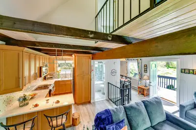 a kitchen and living room with a blue couch at Catskills Mountain Casita Ski, Hike, Fish and Golf! in Denver