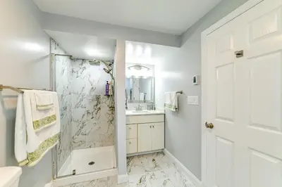 a white bathroom with a shower and a sink at Catskills Mountain Casita Ski, Hike, Fish and Golf! in Denver