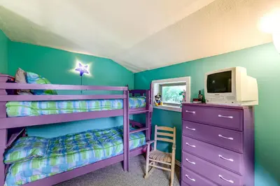 a bedroom with purple bunk beds and a tv at Catskills Mountain Casita Ski, Hike, Fish and Golf! in Denver