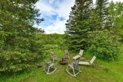 a group of chairs and a fire pit in a yard at Catskills Mountain Casita Ski, Hike, Fish and Golf! in Denver