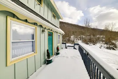 a green house with snow on the porch at Catskills Mountain Casita Ski, Hike, Fish and Golf! in Denver