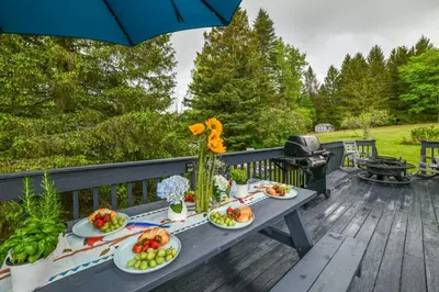 a picnic table with fruits and vegetables on a deck at Catskills Mountain Casita Ski, Hike, Fish and Golf! in Denver