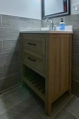 a bathroom vanity with a sink and a mirror at City Gem in Long Island City