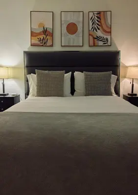 a bedroom with a large bed with two lamps at City Gem in Long Island City