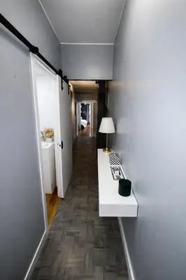 a room with a white counter and a hallway at Next to Manhattan 2 Bedrooms Apartment - Subway 20 steps, Manhattan 1 Stop in Roosevelt Island