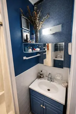 a bathroom with a sink and a blue wall at Next to Manhattan 2 Bedrooms Apartment - Subway 20 steps, Manhattan 1 Stop in Roosevelt Island