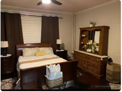 a bedroom with a bed and a dresser and a mirror at Charming Victorian Home in the Heart of White Plains in White Plains