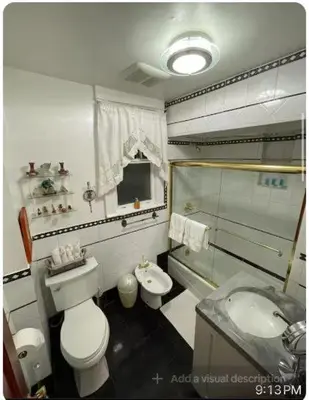 a bathroom with a toilet and a sink at Charming Victorian Home in the Heart of White Plains in White Plains