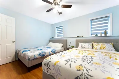 a bedroom with two beds and a ceiling fan at Gorgeous 4BR Home with Hot Tub,Pool& Sauna in East Stroudsburg