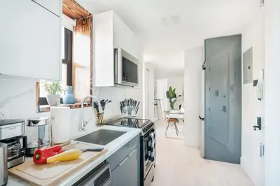 a white kitchen with a sink and a counter top at 48-3FE 2BR Prime Midtown West in New York