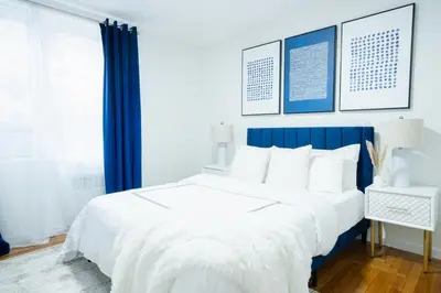 a bedroom with a large white bed with blue accents at 49-3B Newly renovated 2BR WD Midtown East in New York