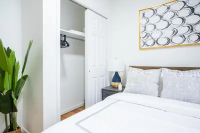 a bedroom with a white bed and a plant at 49-3B Newly renovated 2BR WD Midtown East in New York