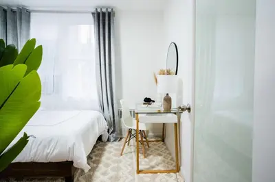a bedroom with a bed and a desk with a mirror at 49-3B Newly renovated 2BR WD Midtown East in New York