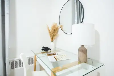 a glass desk with a mirror and a lamp at 49-3B Newly renovated 2BR WD Midtown East in New York
