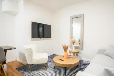 a white living room with a white couch and a table at 49-3B Newly renovated 2BR WD Midtown East in New York