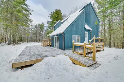 a blue building in the snow next to a forest at Ski, Hike and Golf Pet-Friendly Windham Retreat in Windham