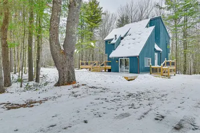 a blue barn in the woods in the snow at Ski, Hike and Golf Pet-Friendly Windham Retreat in Windham