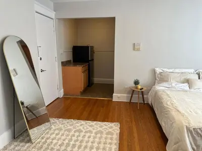 a bedroom with a bed and a mirror and a television at Serene Nordic Escape Close to Yale in New Haven