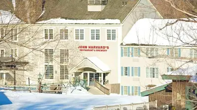 a building with snow on the ground in front of it at Game Night Suite at Jiminy Peak Ski OnOff Sleeps 4 in Hancock