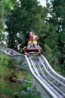 a woman and a child riding on a roller coaster at Game Night Suite at Jiminy Peak Ski OnOff Sleeps 4 in Hancock