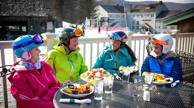 a group of people sitting at a table eating food at Game Night Suite at Jiminy Peak Ski OnOff Sleeps 4 in Hancock
