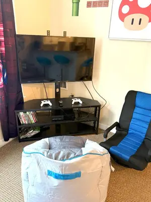 a living room with a tv and a chair at Game Night Suite at Jiminy Peak Ski OnOff Sleeps 4 in Hancock