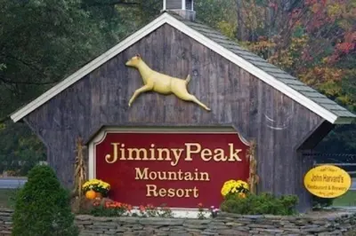 a sign for a mountain resort with a dog on top at Mountain View Suite at Jiminy Peak - Ski On Off - Near Elevator Pool and Lobby in Hancock