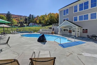 a swimming pool in front of a building at Mountain View Suite at Jiminy Peak - Ski On Off - Near Elevator Pool and Lobby in Hancock