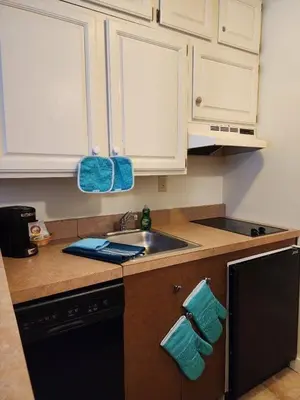 a kitchen with a sink and a counter top at Mountain View Suite at Jiminy Peak - Ski On Off - Near Elevator Pool and Lobby in Hancock