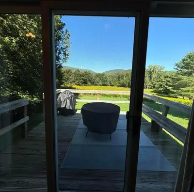 a door open to a porch with a ottoman at 2 BR Condo Mountain Views At Jiminy Peak- Sleeps 7 in Hancock