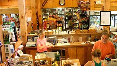 a group of people standing at a counter in a store at 2 BR Condo Mountain Views At Jiminy Peak- Sleeps 7 in Hancock