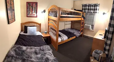 a bedroom with two bunk beds and a desk at 2 BR Condo Mountain Views At Jiminy Peak- Sleeps 7 in Hancock