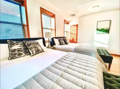 a bedroom with two beds and a couch at La Quinta Loft in Long Island City