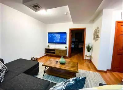 a living room with a couch and a coffee table at La Quinta Loft in Long Island City