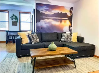 a living room with a couch and a coffee table at La Quinta Loft in Long Island City