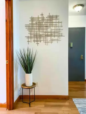 a chandelier hanging over a table with a plant at La Quinta Loft in Long Island City