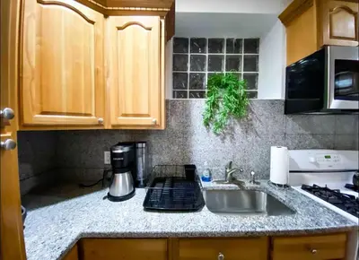 a kitchen with a sink and a counter top at La Quinta Loft in Long Island City
