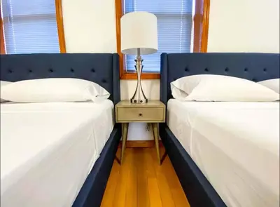 two beds sitting next to each other in a bedroom at La Quinta Loft in Long Island City