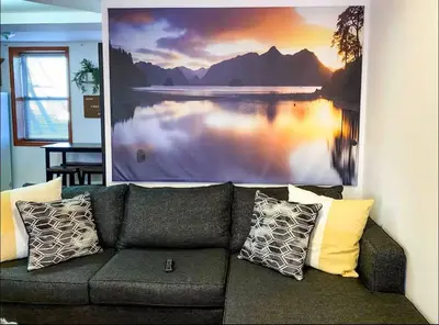 a couch in a living room with a picture on the wall at La Quinta Loft in Long Island City