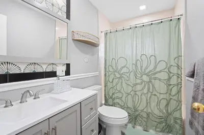 a bathroom with a sink and a shower curtain at Uptown Escape in Mount Vernon
