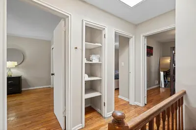 a hallway with white walls and white shelves at Uptown Escape in Mount Vernon