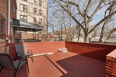 a patio with two chairs and a wooden fence at Uptown Escape in Mount Vernon